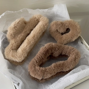 Three plush hair claws in khaki and brown, including rectangular and heart shapes