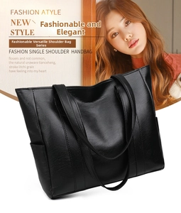 Close-up of black litchi grain leather tote bag with side pocket and wide straps