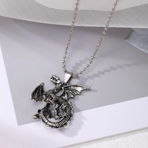 Macro detail of the 3D silver flying dragon pendant with a metallic bead chain