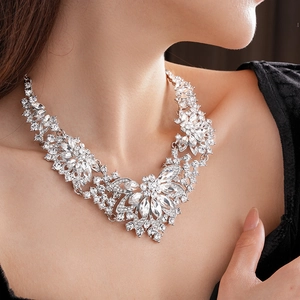 Close-up of elegant silver flower necklace with sparkling crystals on a model neck