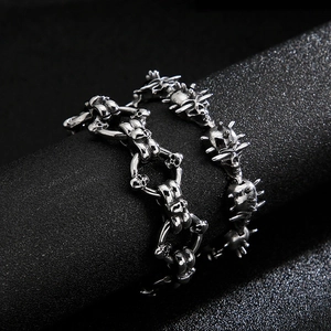 Gothic skull link bracelet in silver and black stainless steel for men on a display stand