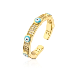 Macro detail of gold plated evil eye ring with blue enamel and cubic zirconia stones