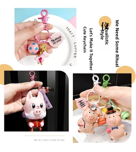 Macro detail of colorful painted metal lobster clasp with cartoon charm and small bell