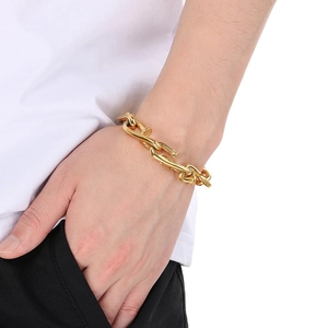 Detail of gold square rivet nail chain bracelet on male wrist for hip hop style