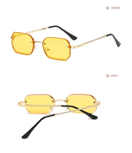 Detail view of small rectangular sunglasses with gold metal temples and yellow lenses