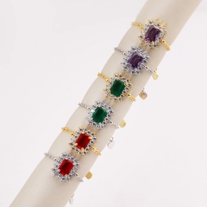 Macro view of vintage rectangular gemstone rings with emerald cut and pavé diamonds