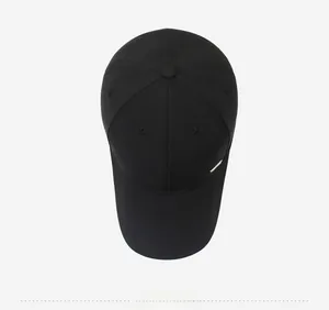 Top view of a classic black cotton baseball cap with a subtle rectangular metal logo