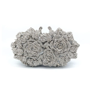 Macro shot of silver crystal rose evening clutch with sparkling rhinestones details