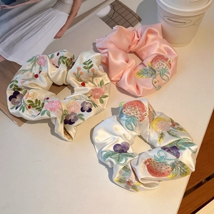 3-piece satin scrunchie set with floral embroidery on pink and beige silk texture