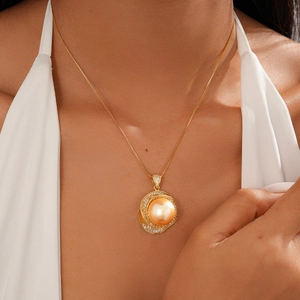 Detail of vintage gold flower sweater necklace with champagne pearl and zirconia stones
