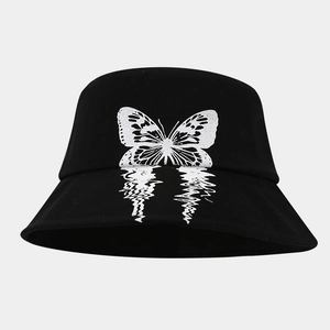 Close-up of black cotton bucket hat featuring a unique mirrored butterfly graphic design