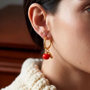 Luxurious Chinese style persimmon and peanut drop earrings worn by a female model