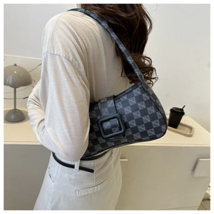 Detail of vintage baguette bag featuring grey checkered logo pattern and matte black buckle