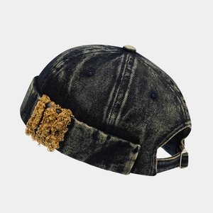 Detail of vintage denim miki hat with adjustable canvas strap and metal buckle