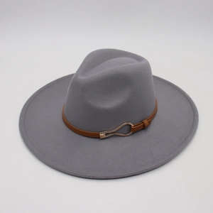 Detail of dark grey wool felt fedora hat featuring brown leather band and gold buckle accent