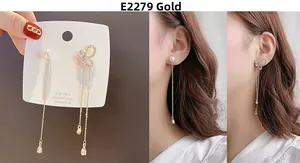 Detail of 925 silver long tassel bow earrings with pearls and crystals on a model