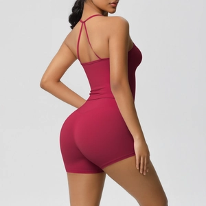 Detail of burgundy yoga bodysuit featuring crisscross back straps and elastic fabric