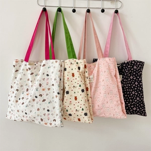 Detailed wall display of sweet cartoon bear embossed shoulder bags in cotton fabric
