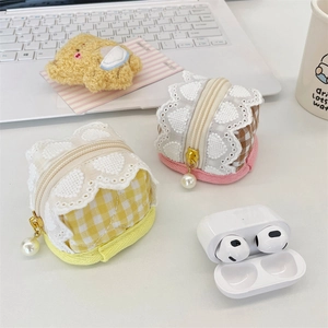 Close-up of checkered fabric earphone case with white lace trim and pearl zipper charm