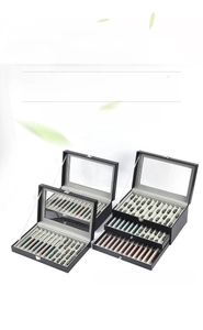 Detail of black leather pen display box with clear glass window and metal lock