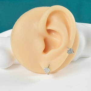 Silver stainless steel heart ring with sparkling Czech rhinestones on a silicone ear model