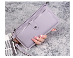 Close-up of light purple long wallet with pebble grain leather and wristlet strap