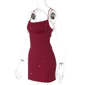 Detail of wine red bodycon dress featuring rhinestone embellishments and a backless design