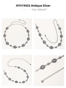 Detail view of antique silver metal chain belt with engraved oval geometric patterns