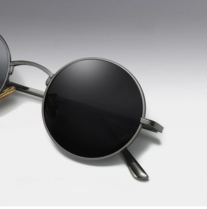 Close-up of steampunk round metal sunglasses with black lenses and rock style frame
