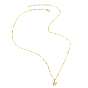 Macro shot of gold letter W pendant with sparkling zircon inlays on a cross chain necklace