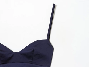 Detail of slim strap and neckline on deep blue satin lace camisole dress