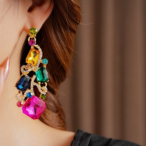 Macro detail of vintage square gold earring set with colorful crystal rhinestones
