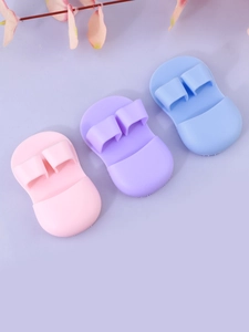 Detail view of mini silicone facial brushes in pink, purple and blue macaron colors