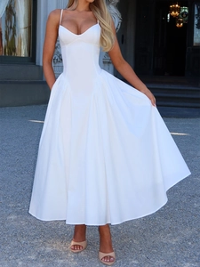Elegant white spaghetti strap long dress with corset bodice and voluminous skirt detail