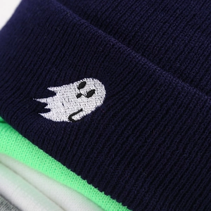 Detail of ghost embroidery on navy blue ribbed knit beanie with color variations