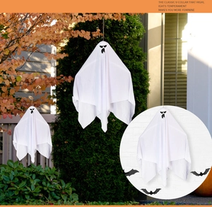 Close-up of white fabric Halloween ghost hanging decorations with spooky faces