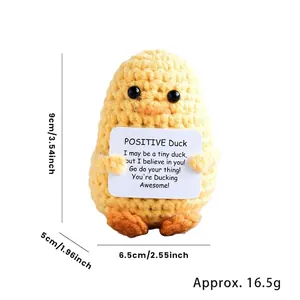 Detailed size view of yellow knitted crochet duck with positive energy card, 9cm height