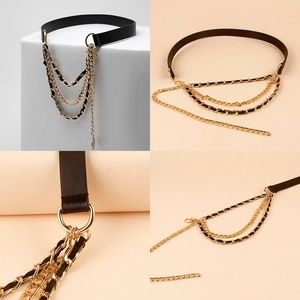 Detail of layered gold metal chains and PU leather belt with decorative rings