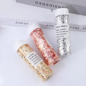 Three 2g bottles of gold, silver and rose gold metallic flakes for cake and dessert decoration