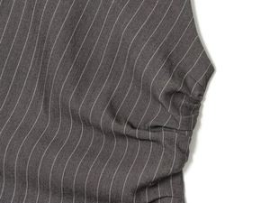 Close-up of dark grey pinstripe fabric showing detailed cotton blend weave texture