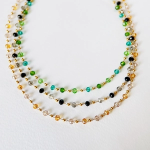 Detail of colorful faceted crystal beads with 18k gold plated stainless steel choker
