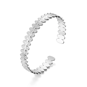 Detail view of silver cuff bracelet featuring fan-shaped wavy edges and textured grain finish