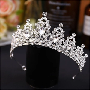 Close-up of a silver baroque wedding tiara with pear-shaped rhinestones and crystal details