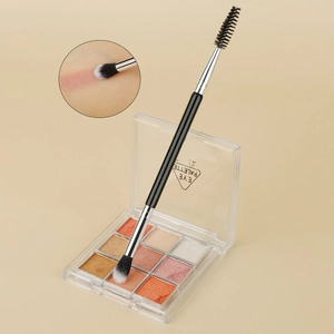 Dual-ended makeup brush detail with blending bristles and a spiral mascara wand head