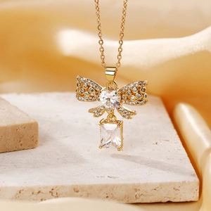 Elegant gold stainless steel necklace with sparkling crystal bow and heart pendant