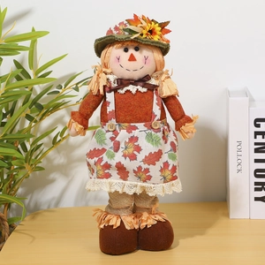 Detailed view of an autumn scarecrow doll with telescopic legs on a warm wooden desk