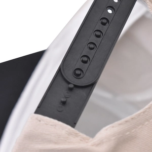 Detail of adjustable black snapback closure on a beige cotton twill baseball cap