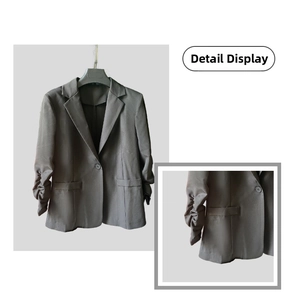 Detail of ruched sleeves and single button closure on dark grey women blazer jacket
