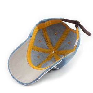 Inside view of denim baseball cap with yellow trim and silver metal buckle for sun protection