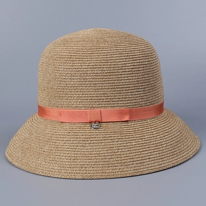 Close-up detail of a Japanese style woven cellulose sun hat with a decorative orange ribbon